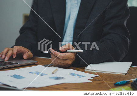 businessman data document graph chart report marketing research development working at office with laptop. businessman data document graph chart report marketing research development working at office with laptop. 92852410