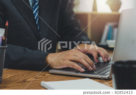 Business typing keyboard computer laptop technology online digital marketing and internet communication social network on table at office. 92852413