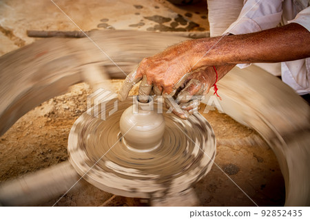 Potter at work makes ceramic dishes. India, Rajasthan. 92852435