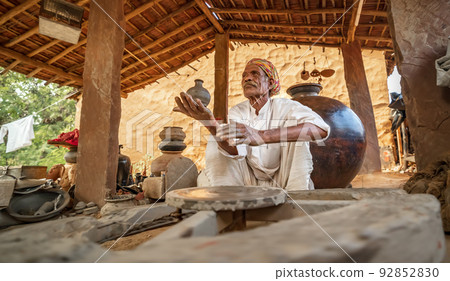 Potter at work makes ceramic dishes. India, Rajasthan. Potter at work makes ceramic dishes. India, Rajasthan. 92852830