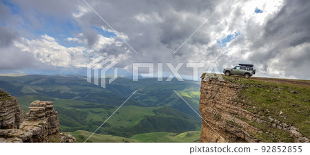 Off road tourist car in the highlands. Expedition travel and vacation, adventures in remote areas. Bermamyt plateau North Caucasus, Karachay-Cherkessia, Russia. 92852855