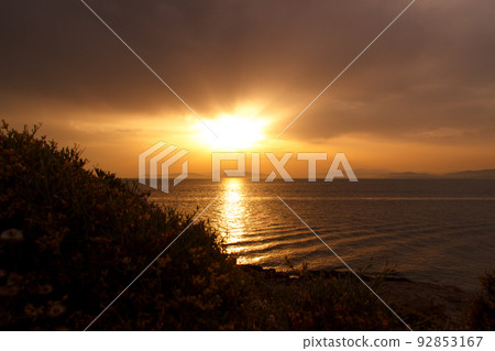 Sunset on the beach, cloudy sky in Greece Sunset on the beach, cloudy sky in Greece 92853167