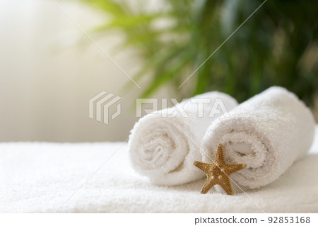 Rolled white towels on the bed in the hotel room Rolled white towels on the bed in the hotel room 92853168
