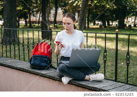 Online jobs for college students. Young woman student girl searching job with laptop outdoors 92853285