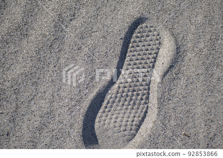 Footprints of shoes on the sandy beach Footprints of shoes on the sandy beach 92853866