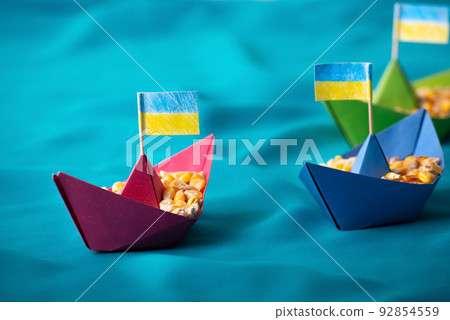 Ships with Ukrainian maize grain made of paper concept Ships with Ukrainian maize grain made of paper concept 92854559