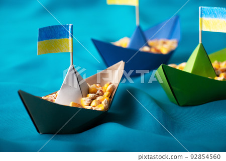 Ships with Ukrainian maize grain made of paper concept Ships with Ukrainian maize grain made of paper concept 92854560