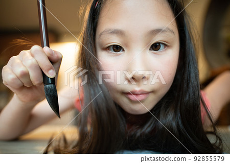 girl with calligraphy brush girl with calligraphy brush 92855579