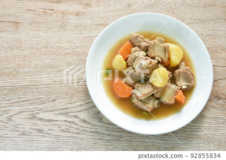 boiled pork bone with potato and carrot stew on plate 92855834