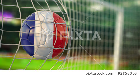 Football ball with flag of France in the net of goal of football stadium. Football championship of FRance concept. 92856016