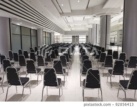 Empty chairs in a modern conference room. Shallow depth of field Empty chairs in a modern conference room. Shallow depth of field 92856413