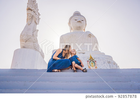 Mother and son tourists on the Big Buddha statue. Was built on a high hilltop of Phuket Thailand Can be seen from a distance 92857878