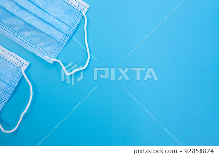 Medical masks on blue background Medical masks on blue background 92858874