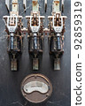 Old, rusty electrical switchboard and ampere meter in an abandoned factory 92859319