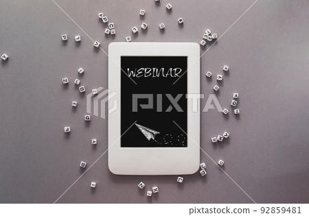 Word Webinar on tablet screen and letter cubes on grey Word Webinar on tablet screen and letter cubes on grey 92859481