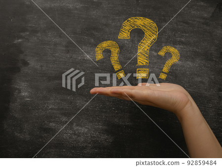 Palm with yellow question marks near blackboard closeup Palm with yellow question marks near blackboard closeup 92859484