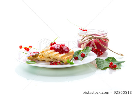 fried bread croutons for breakfast with redcurrant jam in a plate with berries 92860518