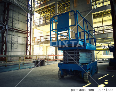Scissor lift platform inside of industrial building Scissor lift platform inside of industrial building 92861288