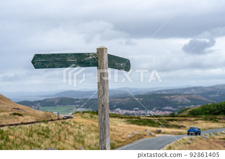 Empty wooden signpost in the mountains. Road sign on the mountain road without information on it 92861405
