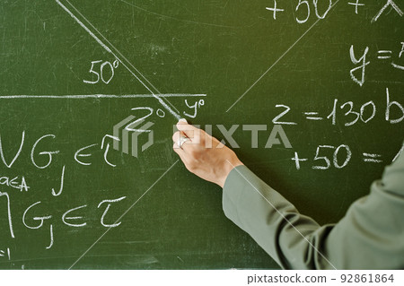 Hand of young teacher of geometry drawing triangle with unknown angle Hand of young teacher of geometry drawing triangle with unknown angle 92861864