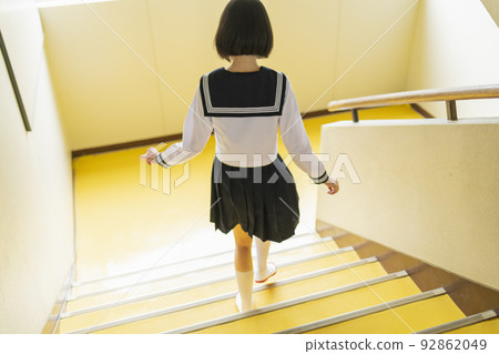 School girls running down the stairs 92862049