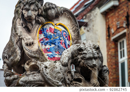 Lion and medieval stone empire shield in Bruges, Belgium Lion and medieval stone empire shield in Bruges, Belgium 92862745