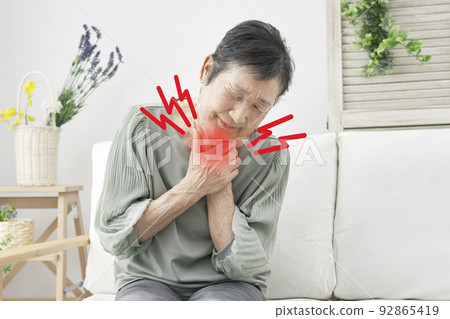 Senior woman whose throat is clogged at home Senior woman whose throat is clogged at home 92865419