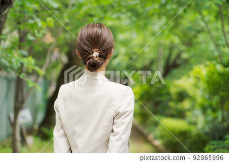 Woman walking in fresh green 92865996