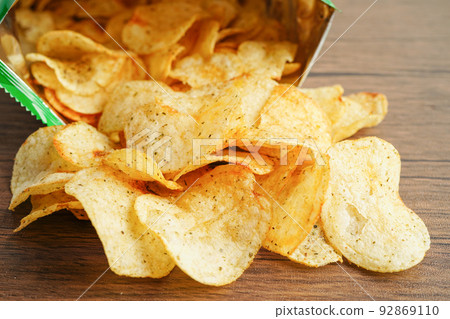 Potato chips in open bag, delicious BBQ seasoning spicy for crips, thin slice deep fried snack fast food in open bag. Potato chips in open bag, delicious BBQ seasoning spicy for crips, thin slice deep fried snack fast food in open bag. 92869110