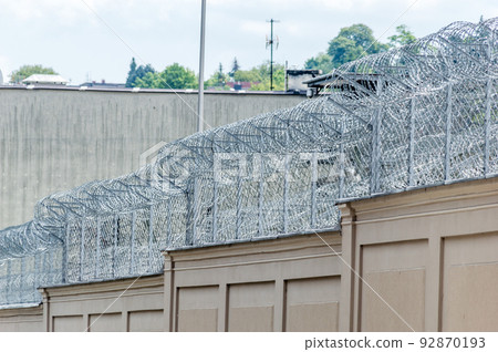 Barbed wire fence used for protection purposes of prison. 92870193