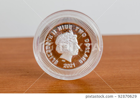 Icon of Elizabeth II Niue two dollars coin. Reverse of Athenian Owl 1 oz silver coin. Fine silver coin from Niue. Icon of Elizabeth II Niue two dollars coin. Reverse of Athenian Owl 1 oz silver coin. Fine silver coin from Niue. 92870629