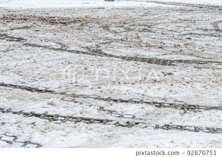 Slushy snow with mud on car parking. Slushy snow with mud on car parking. 92870751