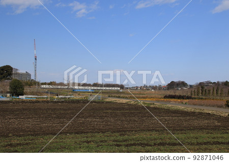 A Tobu Urban Park Line train running across the Minuma rice fields in Saitama City 92871046