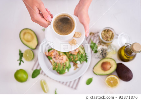 Freshly made Avocado, salmon and cream cheese toasts on a white ceramic plate Freshly made Avocado, salmon and cream cheese toasts on a white ceramic plate 92871876