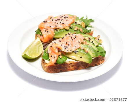 Freshly made Avocado, salmon and cream cheese toasts isolated on white background Freshly made Avocado, salmon and cream cheese toasts isolated on white background 92871877
