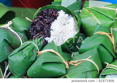 Thai steamed black and white sticky rice wrapped in banana leaf package. Thai steamed black and white sticky rice wrapped in banana leaf package. 92871906