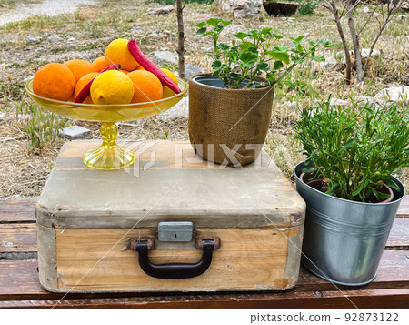 Autumn still life of fruits and vegetables. Fruits and vegetables lie in an old suitcase. Thanksgiving for the harvest in the village church. Autumn still life of fruits and vegetables. Fruits and vegetables lie in an old suitcase. Thanksgiving for the harvest in the village church. 92873122