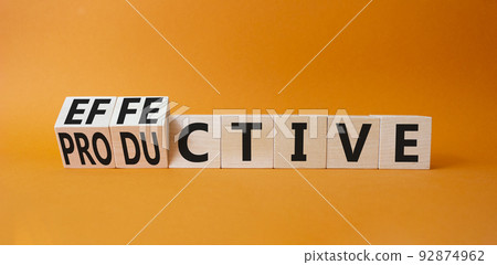 Effective and Productive symbol. Turned cubes with words Productive and Effective. Beautiful orange background. Business and Effective and Productive concept. Copy space Effective and Productive symbol. Turned cubes with words Productive and Effective. Beautiful orange background. Business and Effective and Productive concept. Copy space 92874962