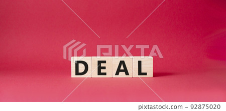 Deal symbol. Concept word Deal on wooden cubes. Beautiful red background. Business and Deal concept. Copy space. Deal symbol. Concept word Deal on wooden cubes. Beautiful red background. Business and Deal concept. Copy space. 92875020