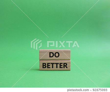 Do better symbol. Wooden blocks with words Do better. Beautiful green background. Business and Do better concept. Copy space. 92875093