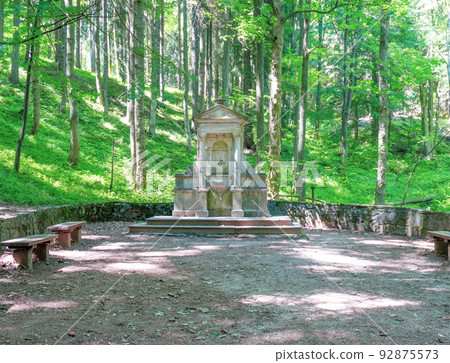 Armenia pramen, Armenian healing spring water and stony mound in park 92875573