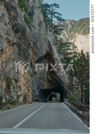 Empty route and small tunnel in mountain Empty route and small tunnel in mountain 92878377