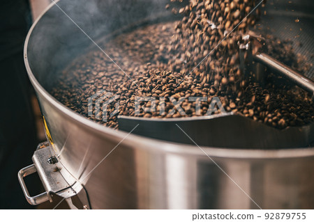 Close up of coffee beans in coffee roasting machine in a small manufacturing Close up of coffee beans in coffee roasting machine in a small manufacturing 92879755