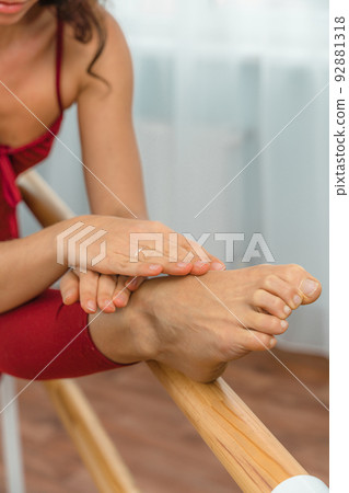 A choreographer in a red jumpsuit is engaged near the machine, in the choreographic hall. A choreographer in a red jumpsuit is engaged near the machine, in the choreographic hall. 92881318