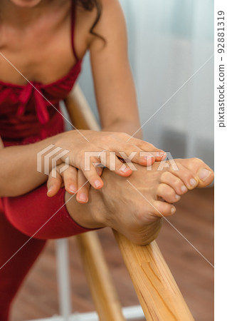 A choreographer in a red jumpsuit is engaged near the machine, in the choreographic hall. A choreographer in a red jumpsuit is engaged near the machine, in the choreographic hall. 92881319