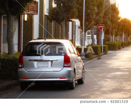 A small minivan parked on the shoulder A small minivan parked on the shoulder 92881329