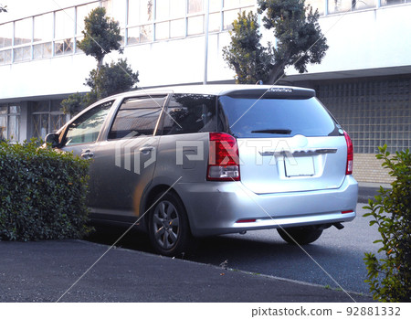 A small minivan parked on the shoulder A small minivan parked on the shoulder 92881332