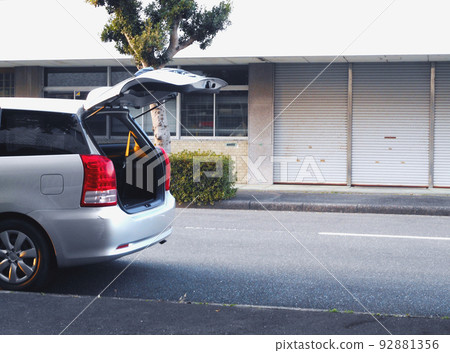 Minivan parked on shoulder with back door open Minivan parked on shoulder with back door open 92881356