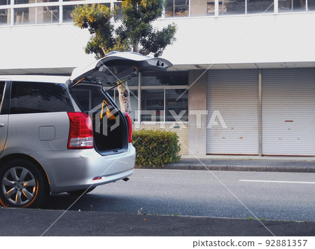 Minivan parked on shoulder with back door open Minivan parked on shoulder with back door open 92881357
