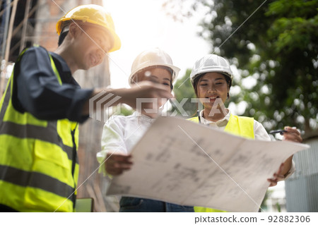 Construction engineers discussion with architects at construction or building site 92882306